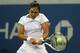 NEW YORK, NY - AUGUST 28: Zarina Diyas of Kazakhstan returns a shot against Catherine 'CiCi' Bellis of the United Statesduring their women's singles second round match on Day Four of the 2014 US Open at the USTA Billie Jean King National Tennis Center o