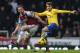 LONDON, ENGLAND - DECEMBER 26: Aaron Ramsey of Arsenal holds off Kevin Nolan of West Ham United during the Barclays Premier League match between West Ham United and Arsenal at Boleyn Ground on December 26, 2013 in London, England. (Photo by Ian Walton/G