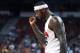 Aug 1, 2014; Las Vegas, NV, USA; USA Team White center DeMarcus Cousins (36) celebrates after assisting on a score during the USA Basketball Showcase at Thomas & Mack Center. Mandatory Credit: Stephen R. Sylvanie-USA TODAY Sports