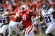 LINCOLN, NE - AUGUST 30: Running back Ameer Abdullah #8 of the Nebraska Cornhuskers runs for a first down past defensive back D'Joun Smith #21 and defensive back Sharrod Neasman #29 of the Florida Atlantic Owls during their game at Memorial Stadium on Aug