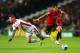 MILTON KEYNES, ENGLAND - AUGUST 26: Javier Hernandez of Manchester United goes past Kyle McFadzean of Milton Keynes Dons during the Capital One Cup Second Round match between MK Dons and Manchester United at Stadium mk on August 26, 2014 in Milton Keynes,