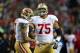 SEATTLE, WA - JANUARY 19: (R-L) Guard Alex Boone #75 smiles alongisde quarterback Colin Kaepernick #7 of the San Francisco 49ers in the first half against the Seattle Seahawks during the 2014 NFC Championship at CenturyLink Field on January 19, 2014 in S