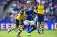 LEICESTER, ENGLAND - AUGUST 31: Aaron Ramsey of Arsenal wins the ball from Liam Moore of Leicester City during the Barclays Premier League match between Leicester City and Arsenal at The King Power Stadium on August 31, 2014 in Leicester, England. (Photo