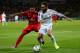 CARDIFF, WALES - AUGUST 12: Dani Carvajal of Real Madrid is closed down by Carlos Bacca of Sevilla during the UEFA Super Cup between Real Madrid and Sevilla FC at Cardiff City Stadium on August 12, 2014 in Cardiff, Wales. (Photo by Clive Mason/Getty Ima