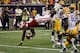 HOUSTON, TX - AUGUST 30: Melvin Gordon #25 of the Wisconsin Badgers dives over Jalen Mills #18 of the LSU Tigers for a touchdown in the second quarter at NRG Stadium on August 30, 2014 in Houston, Texas. (Photo by Bob Levey/Getty Images)