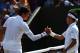 LONDON, ENGLAND - JULY 01: Kei Nishikori of Japan shakes hands with Milos Raonic of Canada after his Gentlemen's Singles fourth round match on day eight of the Wimbledon Lawn Tennis Championships at the All England Lawn Tennis and Croquet Club on July 1,