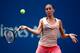 NEW YORK, NY - SEPTEMBER 01: Flavia Pennetta of Italy returns a shot against Casey Dellacqua of Australia during their women's singles fourth round match on Day Eight of the 2014 US Open at the USTA Billie Jean King National Tennis Center on September 1,