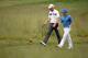 NORTON, MA - AUGUST 31: Rory McIlroy of Northern Ireland and Chris Kirk walk off of the 13th hole during the third round of the Deutsche Bank Championship at the TPC Boston on August 31, 2014 in Norton, Massachusetts. (Photo by Ross Kinnaird/Getty Image