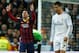 MADRID, SPAIN - MARCH 23: Lionel Messi of Barcelona celebrates scoring his team's third goal as Cristiano Ronaldo of Real Madrid looks dejected during the La Liga match between Real Madrid CF and FC Barcelona at the Bernabeu on March 23, 2014 in Madrid,