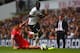 LONDON, ENGLAND - AUGUST 31: Emmanuel Adebayour of Spurs is tackled by Dejan Lovren of Liverpool during the Barclays Premier League match between Tottenham Hotspur and Liverpool at White Hart Lane on August 31, 2014 in London, England. (Photo by Jamie M