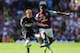 BIRMINGHAM, ENGLAND - AUGUST 31: Carlos Sanchez of Aston Villa is challenged by Stephen Quinn of Hull City during the Barclays Premier League match between Aston Villa and Hull City at Villa Park on August 31, 2014 in Birmingham, England. (Photo by Clive