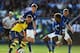 LEICESTER, ENGLAND - AUGUST 31: Alex Oxlade-Chamberlain of Arsenal takes on Dean Hammond, Paul Konchesky and Liam Moore of Leicester City during the Barclays Premier League match between Leicester City and Arsenal at The King Power Stadium on August 31,