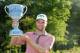 NORTON, MA - SEPTEMBER 01: Chris Kirk is presented with the winner's trophy after winning the Deutsche Bank Championship at the TPC Boston on September 1, 2014 in Norton, Massachusetts. (Photo by Jim Rogash/Getty Images)