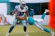MIAMI GARDENS, FL - AUGUST 23: Terrance Williams #83 of the Dallas Cowboys tries to elude tackler Will Davis #29 of the Miami Dolphins during a preseason game at Sun Life Stadium on August 23, 2014 in Miami Gardens, Florida. (Photo by Rob Foldy/Getty Im