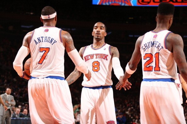 NEW YORK, NY - MARCH 31: J.R. Smith #8 of the New York Knicks high-fives teammates Carmelo Anthony #7 and Iman Shumpert #21 in a game against the Boston Celtics on March 31, 2013 at Madison Square Garden in New York City.  NOTE TO USER: User expressly ack