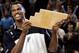 David Robinson displays his community service award before a Spurs game.