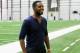 OWINGS MILLS, MD - NOVEMBER 13: UFC fighter Jon Jones waits to be interviewed after attending a news conference with his brother defensive end Arthur Jones #97 of the Baltimore Ravens (not pictured) during a at the teams training facility November 13, 2