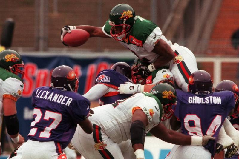 As a Barcelona Dragon, Lawrence Phillips vaults over the line of the Frankfurt Galaxy in an NFL Europe game in June 1999.