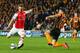 HULL, ENGLAND - MAY 04: Aaron Ramsey of Arsenal (L) scores their second goal as Robbie Brady of Hull City attempts to block during the Barclays Premier League match between Hull City and Arsenal at KC Stadium on May 4, 2015 in Hull, England. (Photo by A