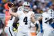 Raiders quarterback Derek Carr throwing against the Detroit Lions defense.
