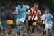 MANCHESTER, ENGLAND - DECEMBER 26: Bacary Sagna of Manchester City is pursued by Fabio Borini of Sunderland during the Barclays Premier League match between Manchester City and Sunderland at the Etihad Stadium on December 26, 2015 in Manchester, England.