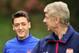 Arsenal's German midfielder Mesut Ozil (L) and French manager Arsene Wenger (R) speak during a team training session for the forthcoming UEFA Champions League Group F football match against SSC Napoli at Arsenal's London Colney training ground in north Lo