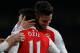 Arsenal's German midfielder Mesut Ozil celebrates with Arsenal's French striker Olivier Giroud (R) after scoring their second goal during the English Premier League football match between Arsenal and Bournemouth at the Emirates Stadium in London on Decemb
