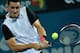 Australia's Bernard Tomic hits a return against Nicolas Mahut of France in their men's singles match on the third day at the Brisbane International tennis tournament on January 5, 2016. AFP PHOTO / Saeed KHAN
-- IMAGE RESTRICTED TO EDITORIAL USE - STRICTL