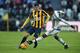 TURIN, ITALY - JANUARY 06: Alex Sandro (R) of Juventus FC competes with Pawel Wszolek of Hellas Verona FC during the Serie A match between Juventus FC and Hellas Verona FC at Juventus Arena on January 6, 2016 in Turin, Italy. (Photo by Valerio Pennicino