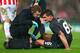 STOKE ON TRENT, ENGLAND - JANUARY 05: Philippe Coutinho of Liverpool receives treatment before leaving the pitch due to the injury during the Capital One Cup semi final, first leg match between Stoke City and Liverpool at the Britannia Stadium on January