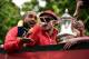 Arsenal's English midfielder Jack Wilshere (R) and Arsenal's English midfielder Theo Walcott hold the trophy as they stand on the top deck of an open-topped bus during the Arsenal victory parade in London on May 31, 2015, following their win in the Englis