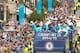 Chelsea's Ivorian striker Didier Drogba (L) holds up the Premier league trophy to fans as the Chelsea team take part in an open-top bus parade through Fulham, south-west London on May 25, 2015 to celebrate winning the Premier League title and the Capital