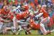 The Clemson defensive line swarms a Georgia Tech running back.