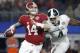 Dec 31, 2015; Arlington, TX, USA; Alabama Crimson Tide quarterback Jake Coker (14) is pressured by Michigan State Spartans defensive lineman Malik McDowell (4) in the third quarter in the 2015 CFP semifinal at the Cotton Bowl at AT&T Stadium. Mandatory Cr
