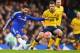 LONDON, ENGLAND - JANUARY 10: Cesc Fabregas of Chelsea is watched by Jamie Ness of Scunthorpe United during the Emirates FA Cup third round match between Chelsea and Scunthorpe United at Stamford Bridge on January 10, 2016 in London, England. (Photo by