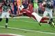 GLENDALE, AZ - JANUARY 03: Wide receiver Larry Fitzgerald #11 of the Arizona Cardinals dives into the endzone to score a 17 yard touchdown against the Seattle Seahawks in the second quarter of the NFL game at University of Phoenix Stadium on January 3, 2