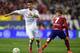 Real Madrid's Portuguese forward Cristiano Ronaldo (L) vies with Atletico Madrid's French forward Antoine Griezmann during the Spanish league football match Club Atletico de Madrid vs Real Madrid CF at the Vicente Calderon stadium in Madrid on October 4,