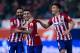MADRID, SPAIN - JANUARY 14: Angel Martin Correa (2ndL) of Atletico de Madrid celebrates scoring their opening goal with teammates Jesus Gamez (L) and Matias Kranevitter (R) during the Copa del Rey Round of 16 second leg match between Club Atletico Madrid