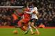 Manchester United's Belgian midfielder Marouane Fellaini (R) tangles with Liverpool's English midfielder Jordon Ibe (L) during the English Premier League football match between Liverpool and Manchester United at Anfield in Liverpool, northwest England, on