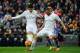 Real Madrid's Colombian midfielder James Rodriguez (L) and Real Madrid's French forward Karim Benzema try to control the ball during the Spanish league football match Real Madrid CF vs Real Sporting de Gijon at the Santiago Bernabeu stadium in Madrid on J