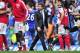 Chelsea's Portuguese manager Andre Villas-Boas (C) is seen on the pitch as Arsenal players celebrate their win in the English Premier League football match between Chelsea and Arsenal at Stamford Bridge in London, on October 29, 2011. Arsenal won the game
