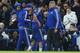 Chelsea's Brazilian-born Spanish striker Diego Costa (C) is helped from the field injured past Chelsea's Dutch manager Guus Hiddink (R) during the English Premier League football match between Chelsea and Everton at Stamford Bridge in London on January 16