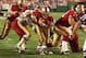 LANDOVER, UNITED STATES: San Francisco 49er quarterback Steve Young (C) dives across the goal line for a second quarter touchdown 14 September as Redskin defensive tackle Dan Wilkenson (L) tries to stop him during the 14 September football game between t