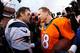 DENVER, CO - JANUARY 24: Peyton Manning #18 of the Denver Broncos and Tom Brady #12 of the New England Patriots speak after the AFC Championship game at Sports Authority Field at Mile High on January 24, 2016 in Denver, Colorado. The Broncos defeated the