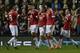 Rooney is congratulated by his team-mates after his sixth goal in six games.