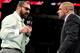 Batista argues with Triple H.
