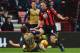 BOURNEMOUTH, ENGLAND - FEBRUARY 07: Mathieu Flamini of Arsenal slides to challenge Dan Gosling of Bournemouth during the Barclays Premier League match between A.F.C. Bournemouth and Arsenal at the Vitality Stadium on February 7, 2016 in Bournemouth, Engl