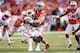 INDIANAPOLIS, IN - DECEMBER 6: Joey Bosa #97 of the Ohio State Buckeyes tackles Melvin Gordon #25 of the Wisconsin Badgers during the Big Ten Championship at Lucas Oil Stadium on December 6, 2014 in Indianapolis, Indiana. Ohio State defeated Wisconsin 59-