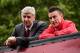 Arsenal's French manager Arsene Wenger (L) and Arsenal's French defender Laurent Koscielny look out from an open top bus during the Arsenal victory parade in London on May 31, 2015, following their win in the English FA Cup final football match on May 30,
