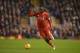 Liverpool's Zaire-born Belgian striker Christian Benteke runs with the ball during the English Premier League football match between Liverpool and West Bromwich Albion at Anfield in Liverpool, northwest England, on December 13, 2015. AFP PHOTO / OLI SCAR